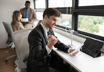 Fototapeta premium Success Caucasian businessman working with paper work and tablet computer at office 