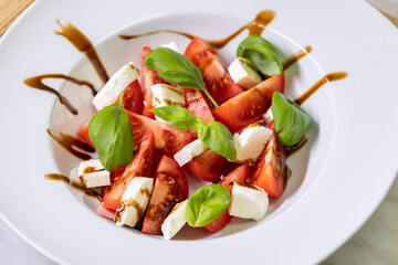 tomato salad with mozzarella, basil and balsamic cream