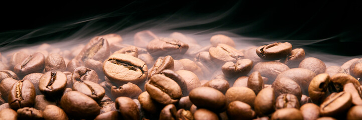 Close Up Studio Shot Of Smoking Roasted Coffee Beans Against Black Background