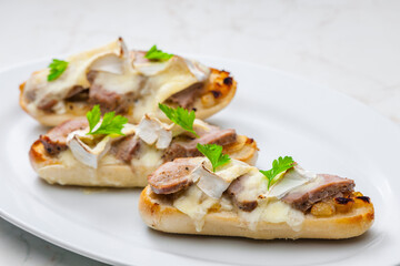 baguette baked with meat, onion and cheese