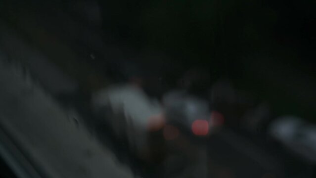 Closeup of rain falling against a window during a heavy rainstorm