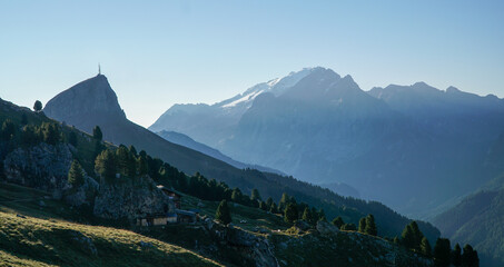 Idyllic atmospheric moody morning in the dolomites: View to Col Rodella and iconic Marmolada Peak in South Tyrol, Italy