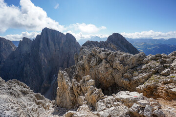At the summit of steep mountain peak on a sunny day: View to the summit of Sassopiatto Plattkofel peak in the dolomites, South Tyrol, Italy