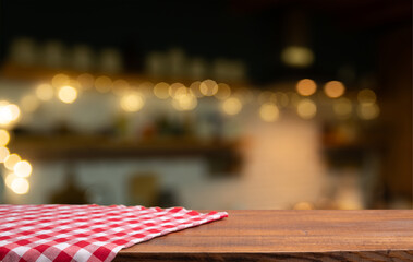 Empty wooden deck table and red checked tablecloth over mint wallpaper background. High quality photo