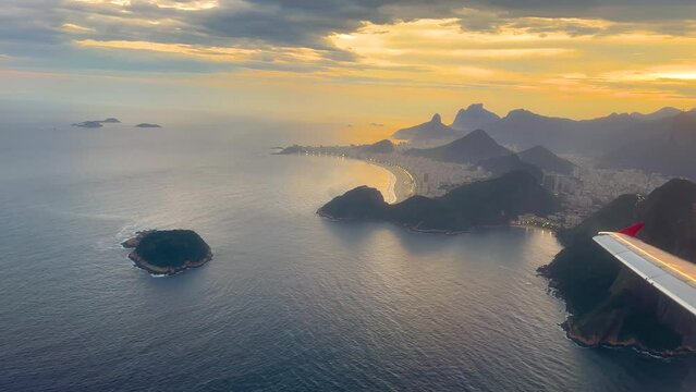 Beautiful aerial view of a plane leaving or arriving in Rio de Janeiro, Brazil. Aerial view of Sugar Loaf Mountain and Copacabana Beach.