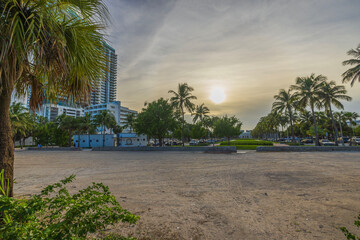 Beautiful sunset view over city of Miami Beach, with vibrant hues painting sky and reflecting on...