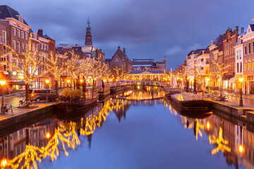 Night Leiden canal Oude Rijn and City Hall in Christmas illumination, Holland, Netherlands.