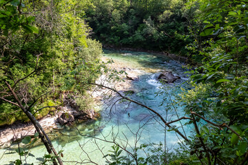 Turquoise creek of Soca river in Bovec, Triglav National Park, Slovenia. Magnificent Soca Valley in breathtaking Julian Alps. Wanderlust in untamed Slovenian Alps. Hiking amidst alpine wilderness