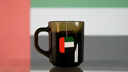 Close-up of a cup of tea with an UAE flag tag hanging from it