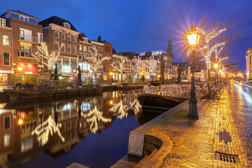 Night Leiden canal Oude Rijn and City Hall in Christmas illumination, Holland, Netherlands.