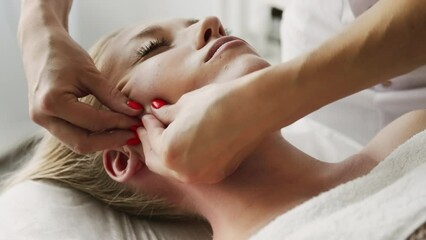 Beautician cosmetologist makes lifting neck massage, pinch and roll technique, professional cosmetic procedure in a beauty clinic salon for client. Skin care and cosmetology spa concept.	
