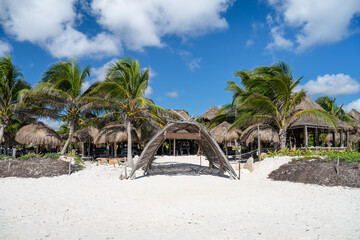 Tropical vacation background with green palms on the beach. Entrance to the tropical hotel on the...
