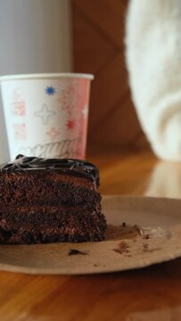Close-up of a fork breaking a chocolate cake