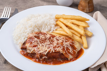 Parmegiana beef, rice and french fries. Typical brazilian executive dish