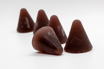 Closeup of cuberdon, a cone-shaped Belgian candy on a white background