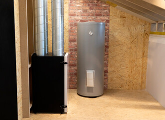 Grey Electric storage water heater with Temperature Display in utility room, brick wooden wall....
