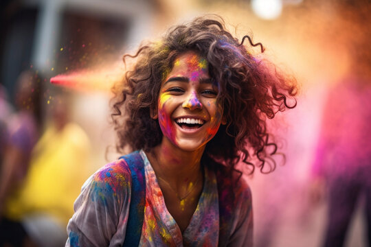 Portrait of young woman in colorful powder on indian street, Holi festival