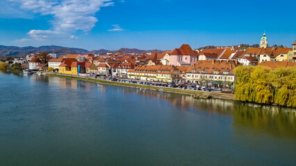 Breathtaking panorama of glistening Drava River as it gracefully winds its way through enchanting city of Maribor, nestled in heart of Slovenia, Europe. Timeless beauty of old town along riverbed