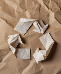 Obraz premium Recycle symbol made of crumpled paper on green background. Eco recycling concept.