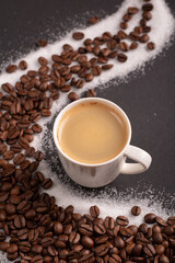 photo a cup of espresso surrounded by aromatic coffee beans, creating a visually pleasing background. With a touch of sugar, it promises a delightful coffee experience captured in this image.