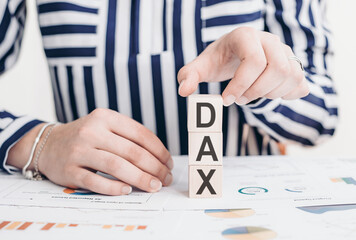 DAX symbol. A wooden blocks symbolizing Deutsche Boerse DAX index price. Business and gold price...