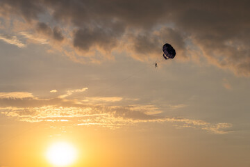 Sunset Soar: Parachute Drifting in the Evening Sky