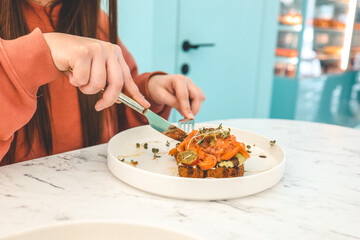 Girl in a cafe eating avocado toast