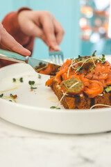 Girl in a cafe eating avocado toast