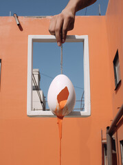 house in the sky with giant egg in giant hand.Illusionistic photography.Minimal creative food concept.Copy space.Generative AI