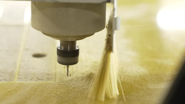 The CNC drills a hole in the plastic. plastic carving. Head close-up