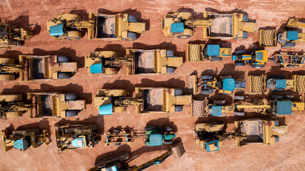 Aerial view of several earthmoving compacting machines for construction. Soil leveling tractors.