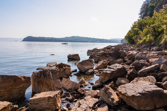 Panoramic view of idyllic coastline of Gulf of Piran, Adriatic Mediterranean Sea, Slovenia, Europe. Summer seaside vacation. Stroll along the tranquil stone beach of Fiesa. Shoreline Slovenian Istria