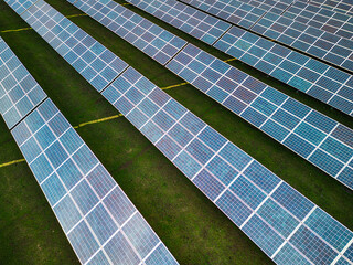 Solar panel produces green, environmentaly friendly energy from the setting sun. Aerial view from drone. Landscape picture of a solar plant that is located inside a valley
