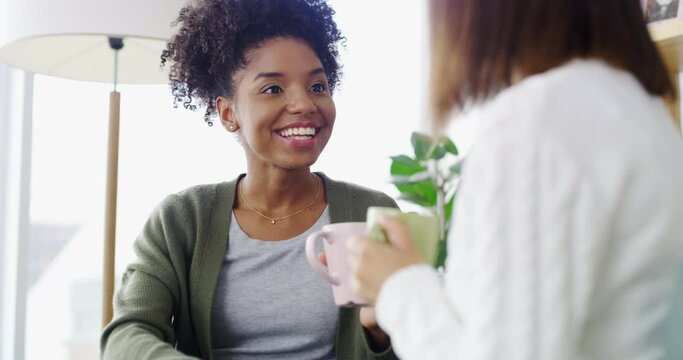 Coffee, conversation and happy friends in the living room bonding, laughing and talking together. Gossip, smile and young women drinking a latte, cappuccino or tea and speaking in the lounge at home.