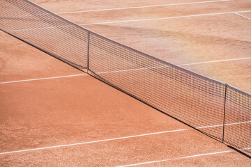 View with a net on the clay tennis court .