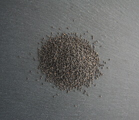 Basil seeds, Ocimum basilicum, on dark grey background
