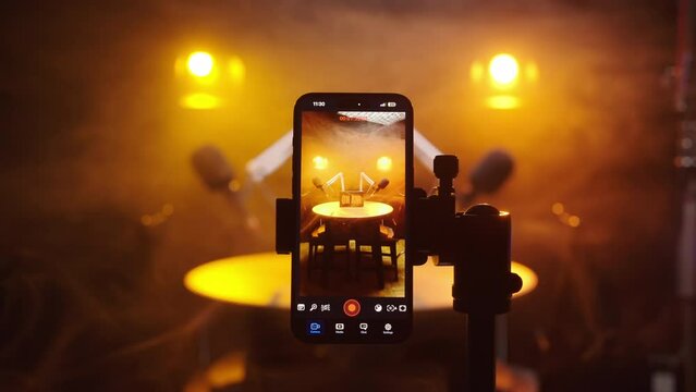 Vertical smartphone recording podcast studio with dramatic lights and smoke 4K