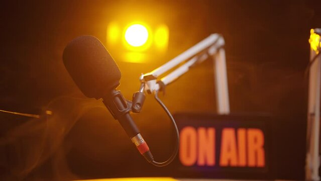 Zooming on podcast microphone On Air in black studio 4K