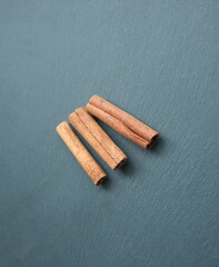 Cinnamon sticks, flavoring ingredient and decoration for Christmas celebration,  on grey stone  background 