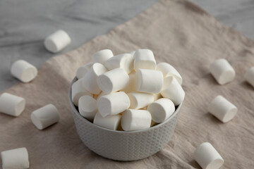 Fototapeta na wymiar White Marshmallows in a Bowl, side view.