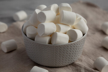Fototapeta na wymiar White Marshmallows in a Bowl, side view. Close-up.