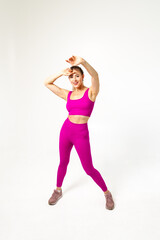 Woman in vibrant pink sports outfit with hand extended towards camera
