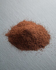 Coffee powder, roasted beans of Coffea arabica, on grey stone background