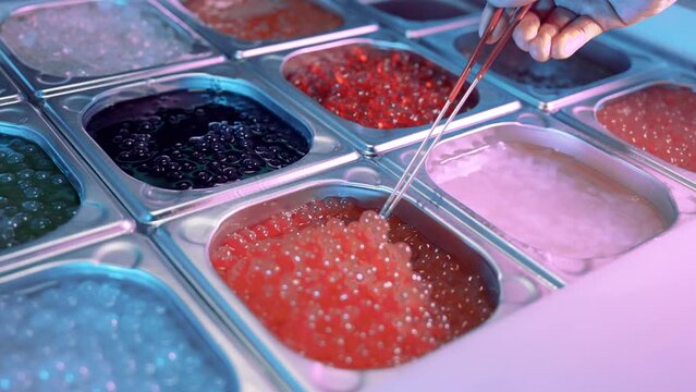 Close up shot of tasty, delicious, sweet boba tea bubbles stired by a spoon