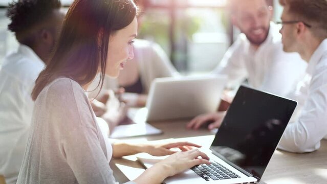 Business woman working on laptop computer in office