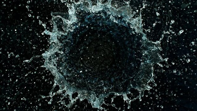 Super Slow Motion Shot of Round Water Splash on Black Background at 1000fps.