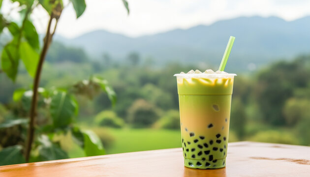 Green matcha bubble tea with ice cubes in cup against tea plantations softlight. Antioxidant and dietary vegan cocktail for healthy breakfast or snack