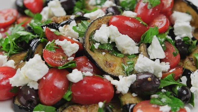 Roasted Eggplant, Tomato salad with kalamata olives and Feta cheese. Rotating video