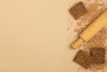 Pieces of bread and wheat grains on the table. Bread baking concept.