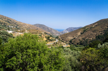 Winding mountain road leading to the seashore